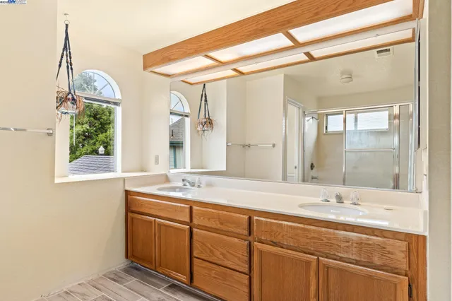 a bathroom with a granite countertop sink mirror and double