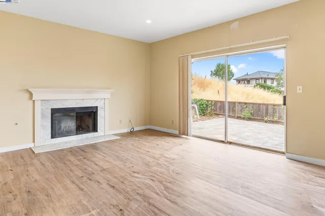 a view of an empty room with a fireplace
