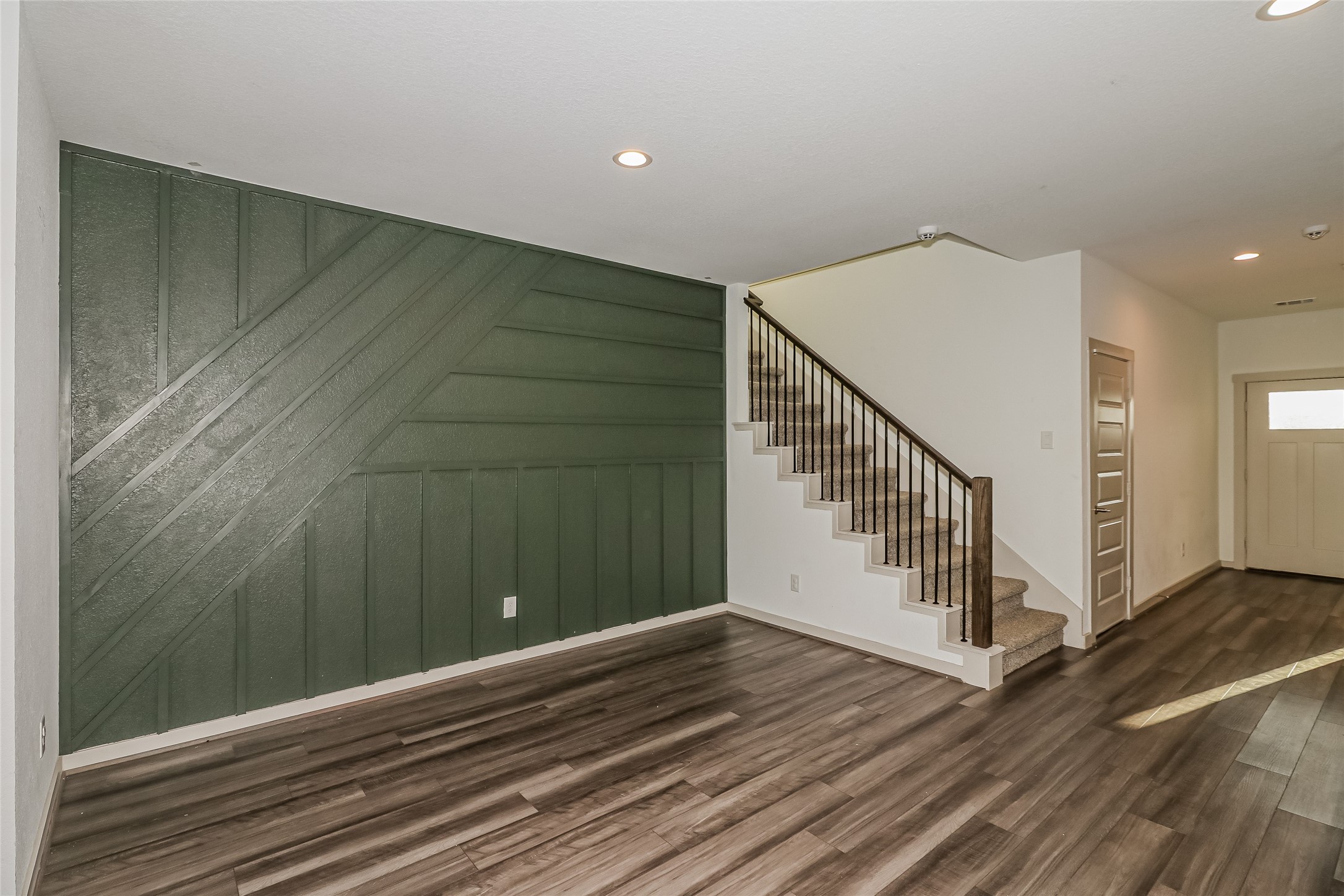 7322 Ramsgate Cliff Lane Richmond, TX 77407 - Photo 7 of 17 a view of a hallway with wooden floor and stairs