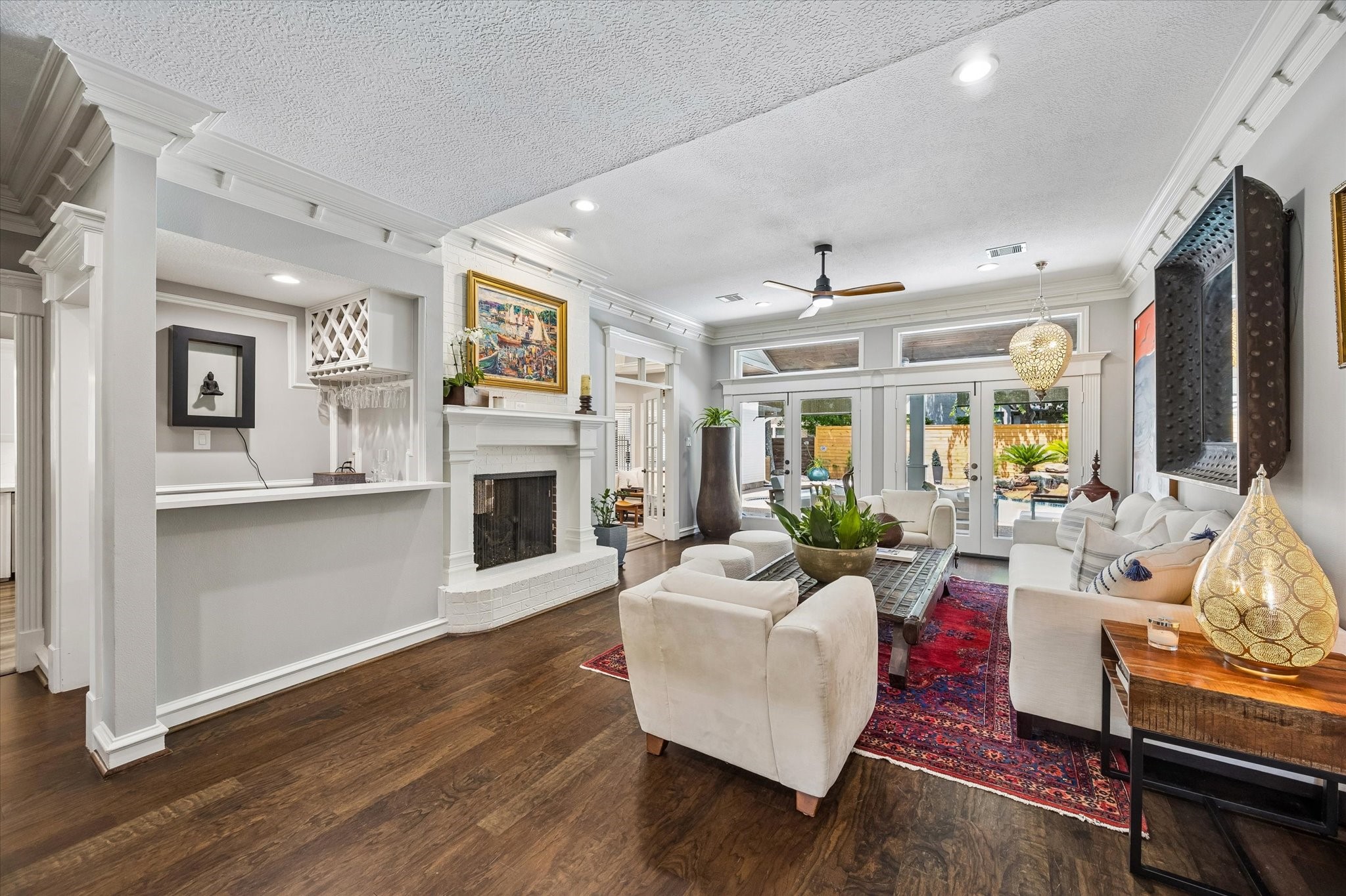 146 Golden Shadow Circle Spring, TX 77381 - Photo 12 of 41 The living room boasts rich wood floors and a crisp white brick fireplace. French doors line the back of the family room, topped with transoms that fill the space with abundant natural light.