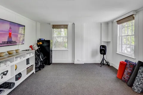 a view of a workspace with furniture and a window