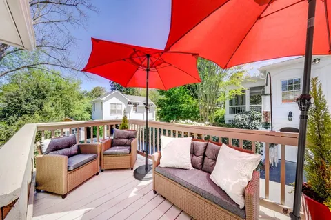 a balcony with furniture and umbrella