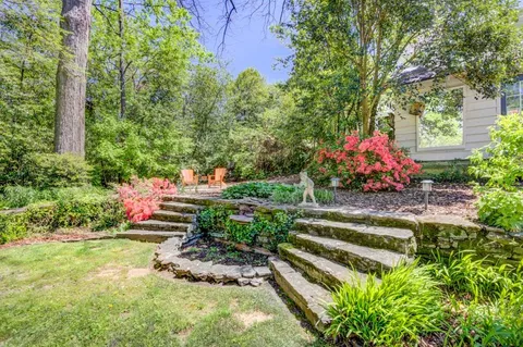 a view of a chair and table in the garden