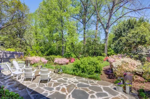 a view of a patio with table and chairs and potted plants