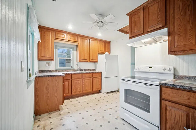 a kitchen with a stove a sink and a refrigerator