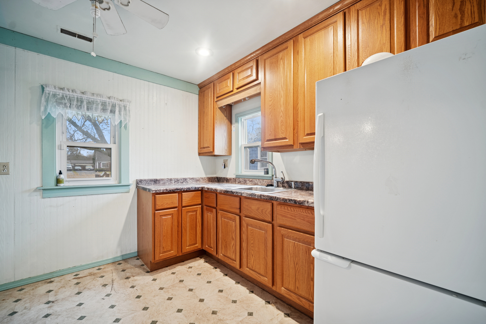 215 Second Street Elgin, IL 60123 - Photo 6 of 19 a kitchen with stainless steel appliances granite countertop a refrigerator sink and wooden cabinets