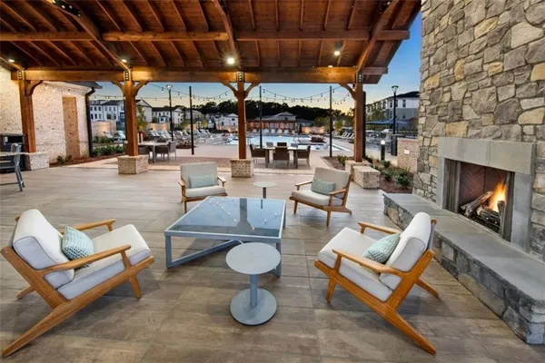 a outdoor living space with patio furniture and a fireplace