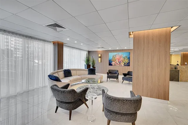 a lobby with furniture and floor to ceiling window