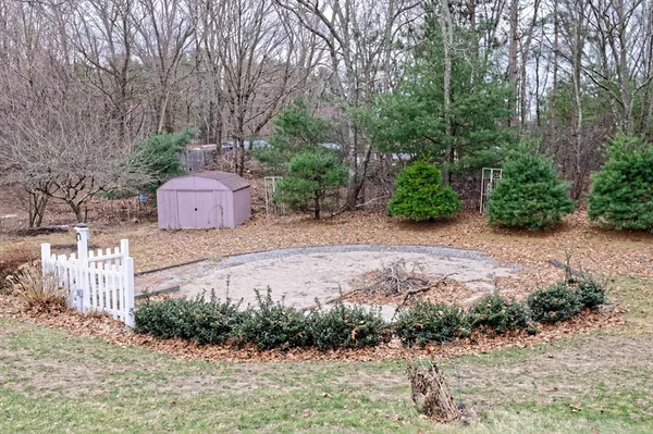 a backyard of a house with table and chairs