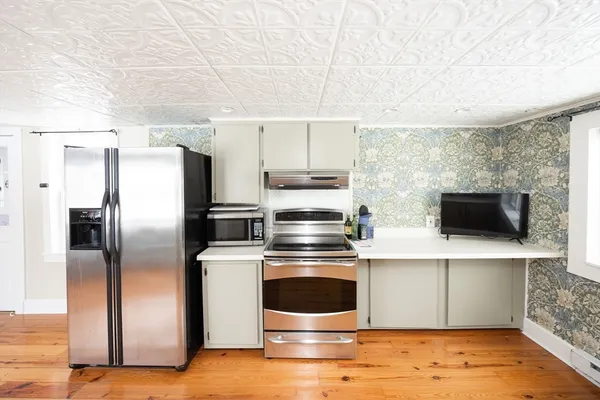 a kitchen with a sink cabinets and appliances
