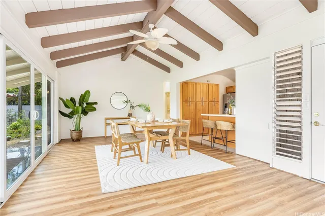 a view of a dining room with furniture a chandelier and wooden floor