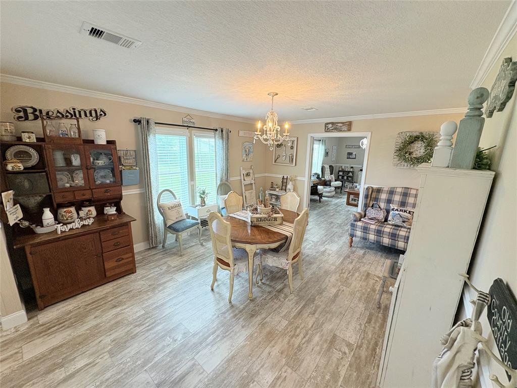 4331 Southwest 10th Way Okeechobee, FL 34974 - Photo 11 of 49 a living room with furniture and a flat screen tv
