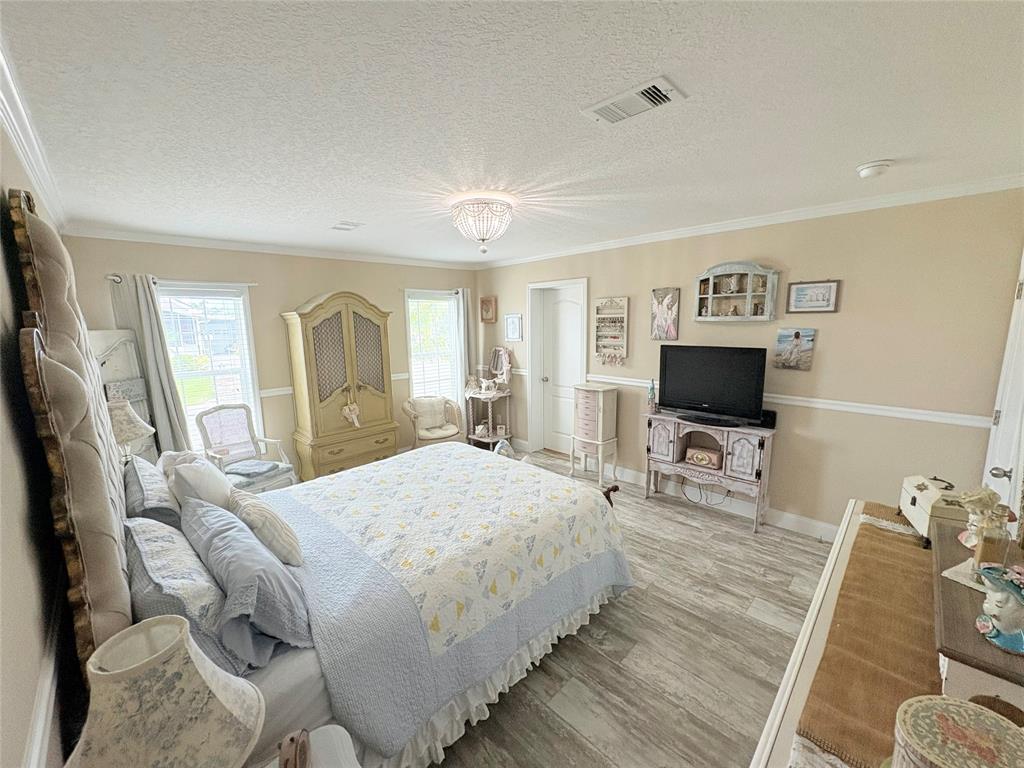 4331 Southwest 10th Way Okeechobee, FL 34974 - Photo 13 of 49 a bedroom with a bed and a flat screen tv