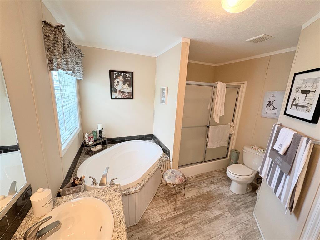 4331 Southwest 10th Way Okeechobee, FL 34974 - Photo 16 of 49 a bathroom with a granite countertop sink toilet and shower
