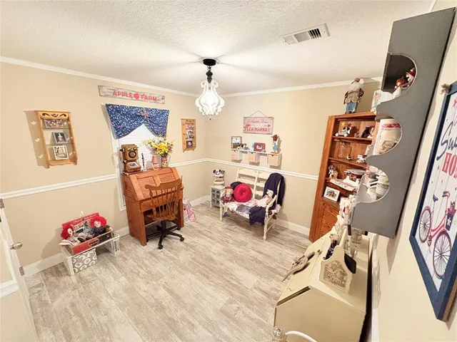 a bedroom with furniture and a flat screen tv