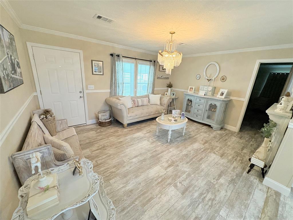 4331 Southwest 10th Way Okeechobee, FL 34974 - Photo 30 of 49 a living room with furniture and a wooden floor