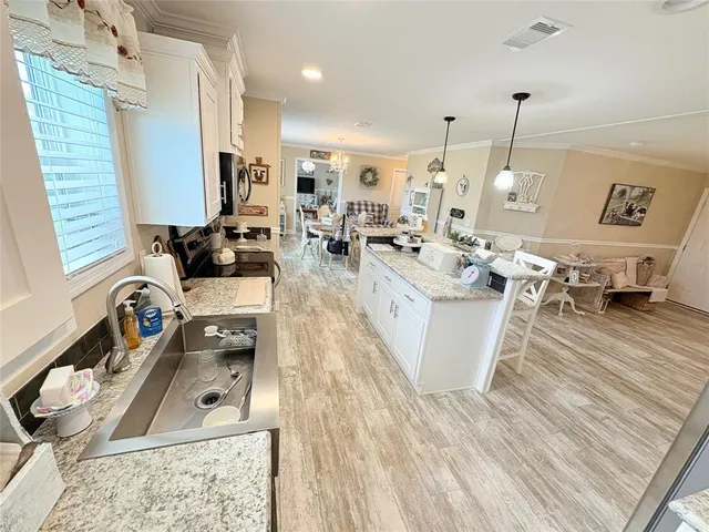 a living room with lots of furniture and a wooden floor