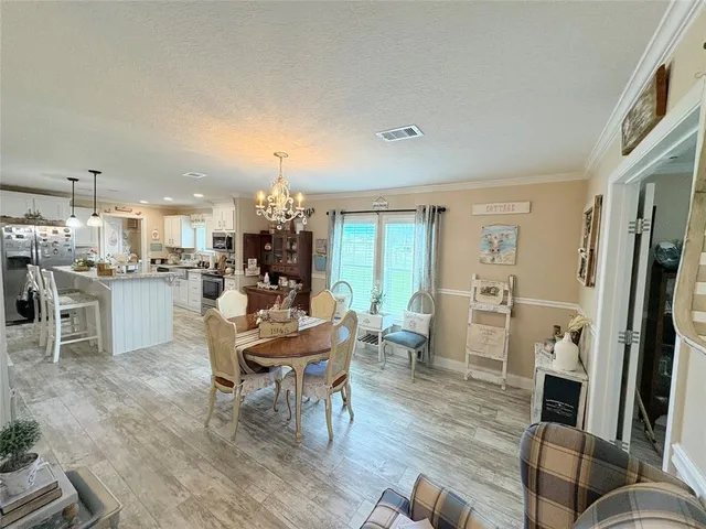 a living room with furniture a dining table and kitchen view