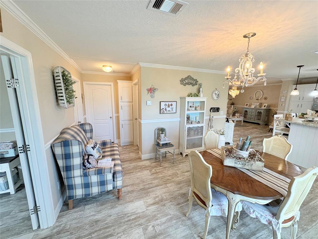 4331 Southwest 10th Way Okeechobee, FL 34974 - Photo 10 of 49 a living room with furniture and a chandelier