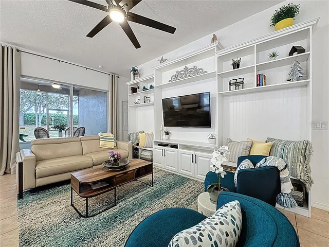 a kitchen that has a lot of white cabinets and stainless steel appliances