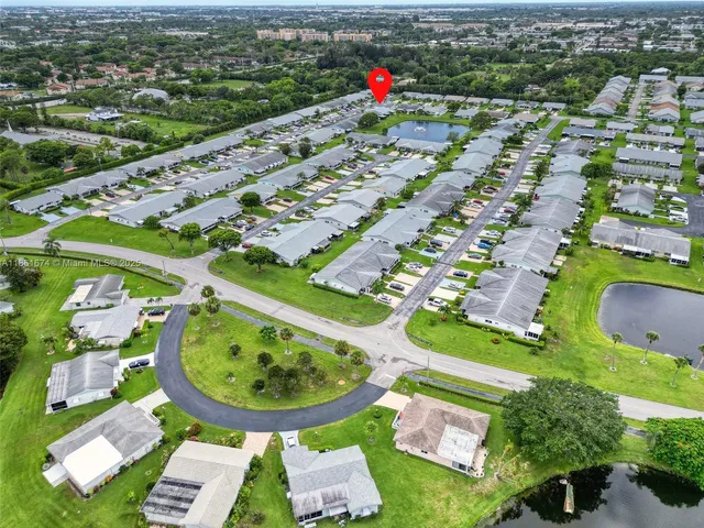 an aerial view of a house with a swimming pool yard and mountain view in back