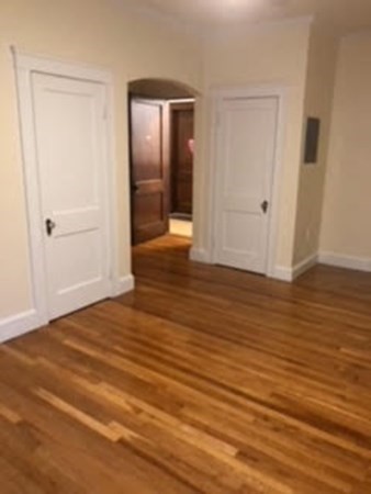 21 Sanborn Street, Unit 5 Reading, MA 01867 - Photo 6 of 8 a view of an empty room with wooden floor