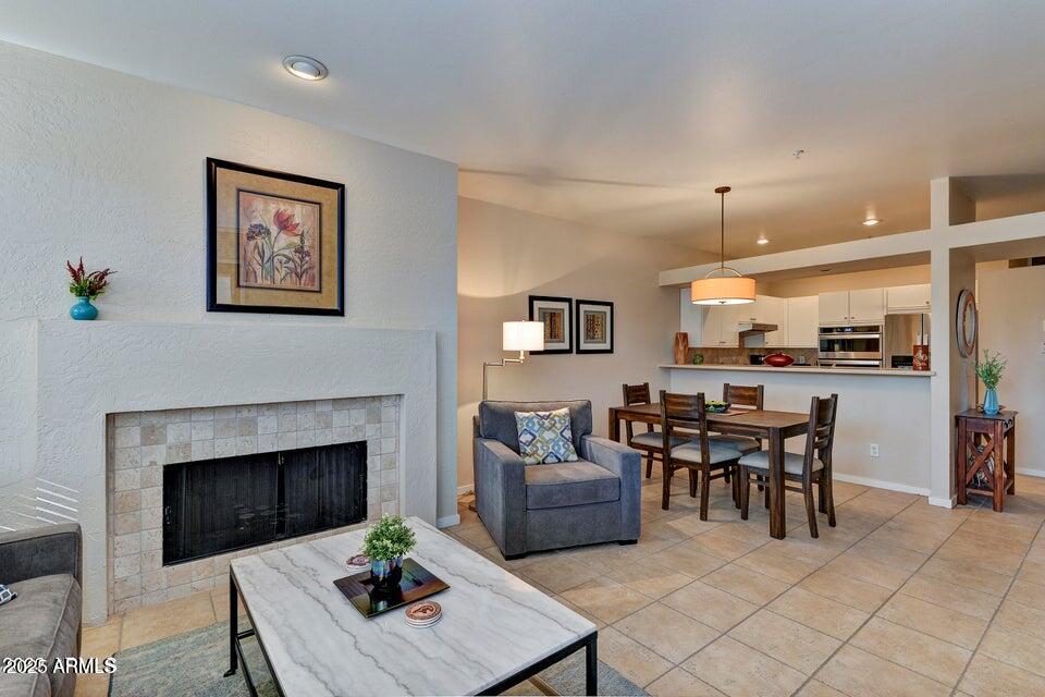 7700 East Gainey Ranch Road, Unit 104 Scottsdale, AZ 85258 - Photo 3 of 14 a living room with furniture a table and kitchen view