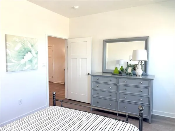 a bedroom with a bed and a dresser in it