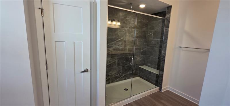 1002 Whistler Way Mars, PA 16046 - Photo 16 of 23 a bathroom with a glass shower door