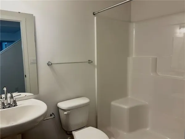 a white toilet sitting next to a bathroom sink