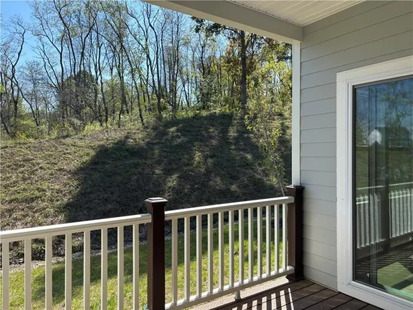 a view of a balcony with yard