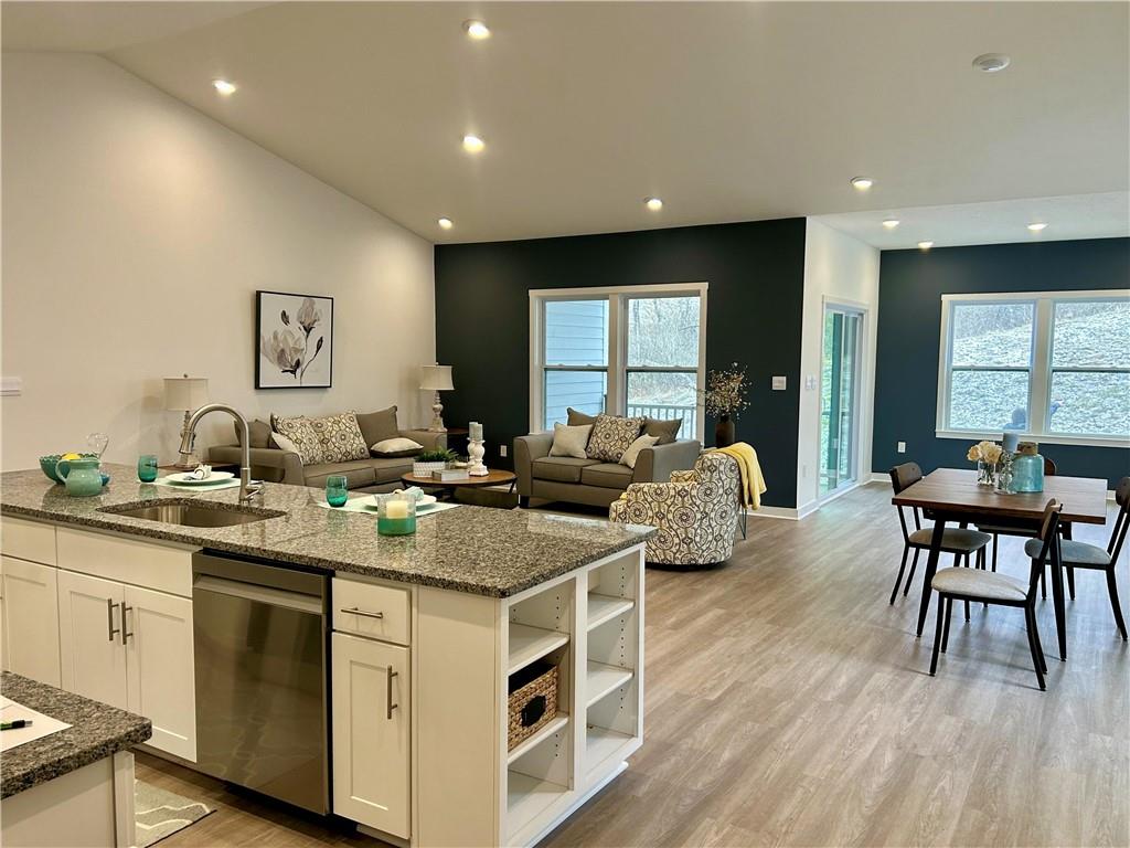 1002 Whistler Way Mars, PA 16046 - Photo 5 of 23 a kitchen with stainless steel appliances granite countertop a stove a sink a dining table and chairs