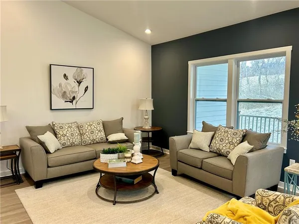a living room with furniture and a large window