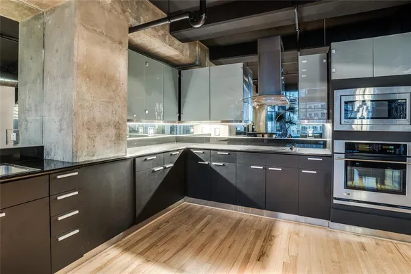 a kitchen with stainless steel appliances granite countertop a sink stove and cabinets