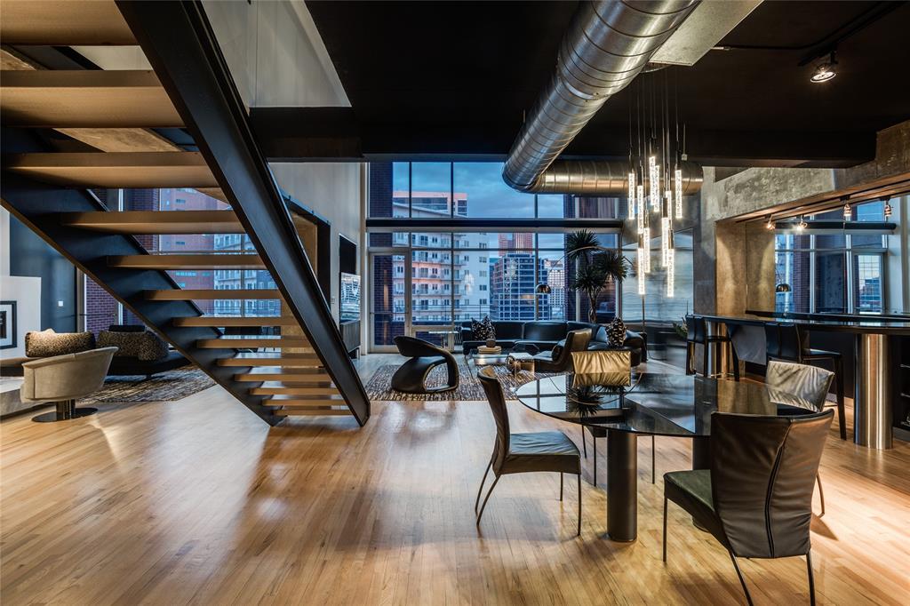 2011 Cedar Springs Road, Unit 606 Dallas, TX 75201 - Photo 16 of 33 a dining room with wooden floor table and chairs
