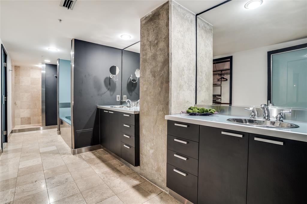 2011 Cedar Springs Road, Unit 606 Dallas, TX 75201 - Photo 20 of 33 a bathroom with a double vanity sink a and a mirror