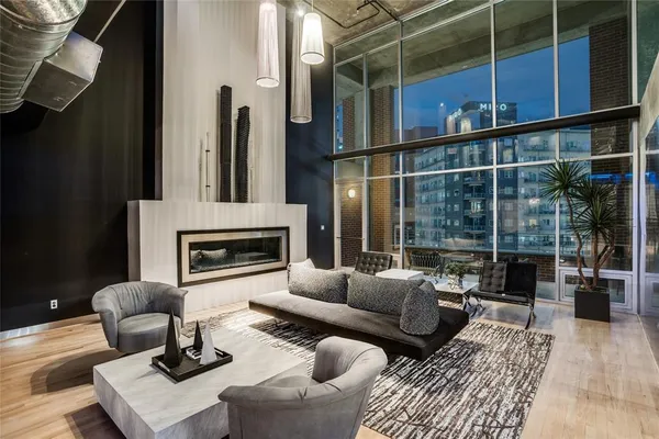 a living room with furniture a rug and a fireplace