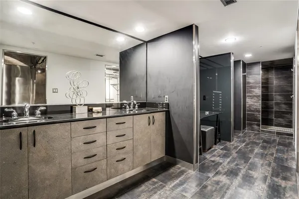 a bathroom with double vanity and a shower