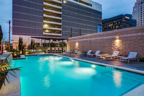 a view of a swimming pool with outdoor seating