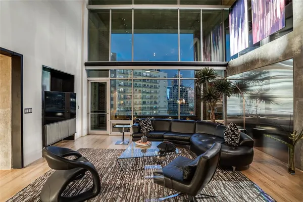 a living room with furniture and floor to ceiling window