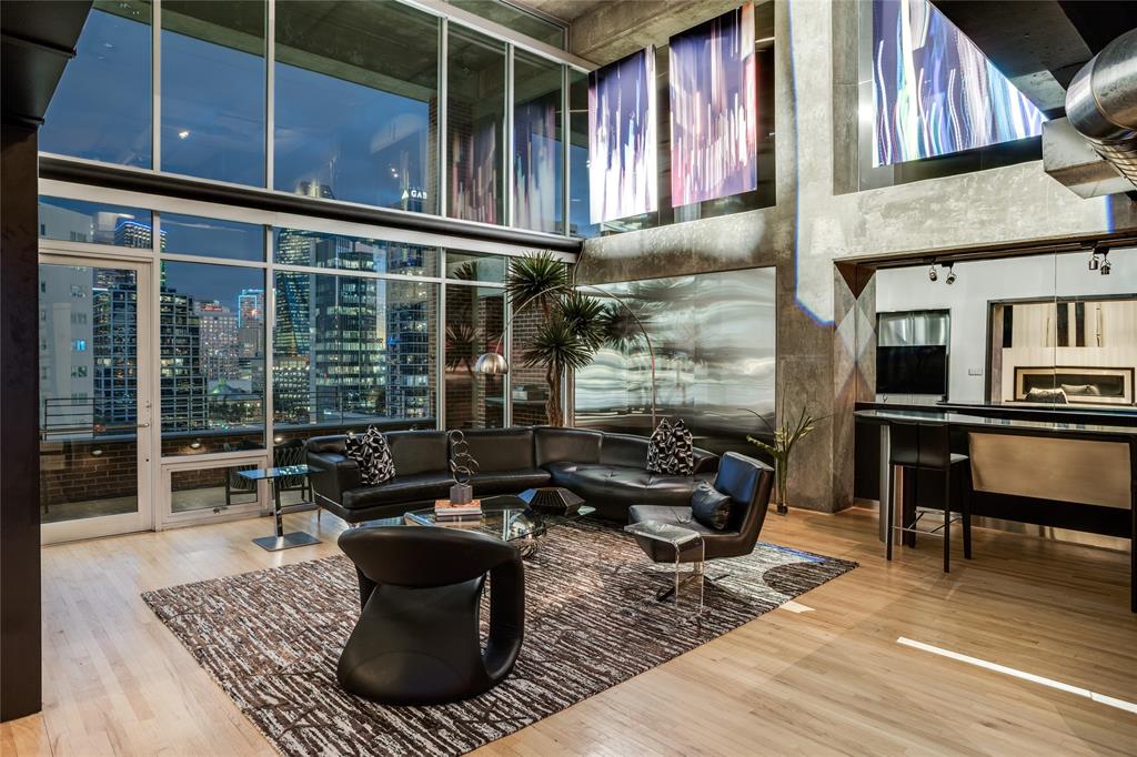 2011 Cedar Springs Road, Unit 606 Dallas, TX 75201 - Photo 9 of 33 a living room with furniture a rug and a fireplace