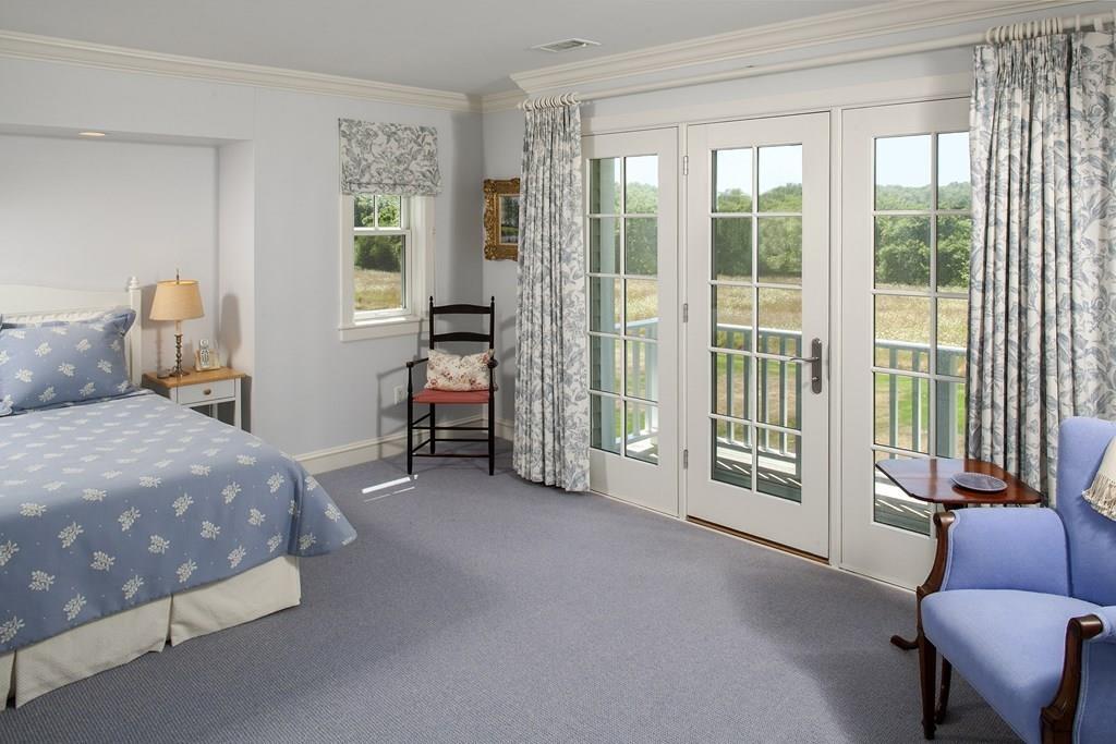 523 Barneys Joy Road Dartmouth, MA 02748 - Photo 21 of 39 a bedroom with a bed and a couch next to a window
