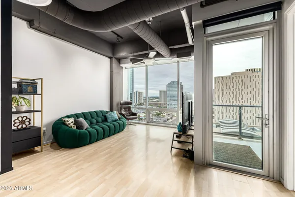 a living room with furniture and a floor to ceiling window