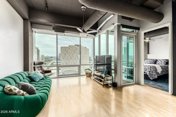 a living room with furniture and a floor to ceiling window