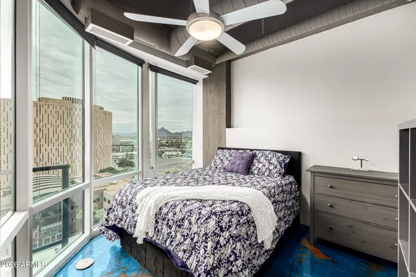 a bed sitting in a bedroom next to a window