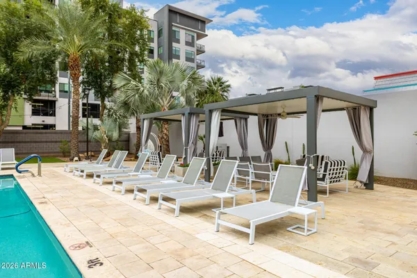 a view of swimming pool with outdoor seating and plants