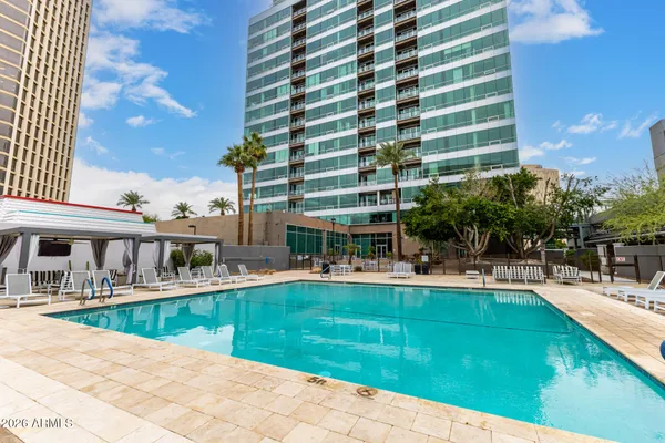 a view of a swimming pool with a lounge chairs