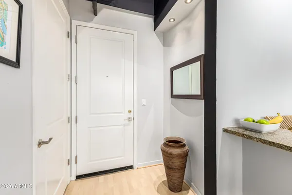 a hallway with table and flowerpot