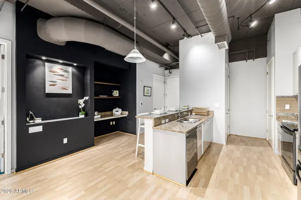 a kitchen with cabinets and wooden floor