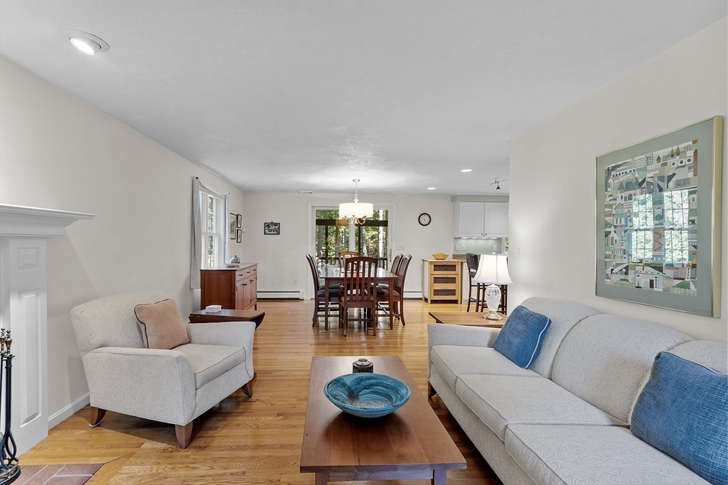 3 Brandy Hollow Littleton, MA 01460 - Photo 11 of 40 a living room with furniture a dining table and a fireplace